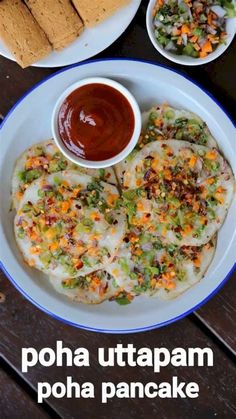 a plate with some food on it next to two bowls of sauce and pita bread