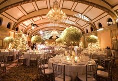 a banquet hall with chandeliers and tables set up for formal dinnereons