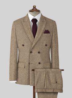 The Irish Brown Herringbone Tweed Suit will become the standard of business dressing and by far the most ubiquitous option. Crafted from wool, the Irish Brown color of the suit will surely influence a veteran dresser to buy the suit for building a sharp wardrobe. Team it up with a white shirt and dark brown derby shoes. 
 
 Look Includes  Irish Brown Herringbone Tweed Fabric  Double Breasted Jacket Style  Peak Lapel  Horn Brown Buttons  Single Vent  Three Cuff Buttons  Two Welted Back Pockets on Timeless Business Tweed Jacket With Herringbone Pattern, Timeless Tweed Jacket With Herringbone Pattern For Business, Winter Formal Tweed Three-piece Suit, Herringbone Tweed Jacket For Business, Business Tweed Jacket With Herringbone Pattern, Formal Tweed Three-piece Suit With Notch Lapel, Formal Tweed Suit With Suit Collar, Formal Three-piece Tweed Suit With Notch Lapel, Tailored Herringbone Pattern Suits