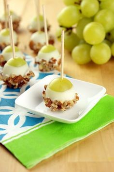 two pictures of grapes on a plate with toothpicks in the middle and green grapes next to them