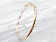 This can easily be worn alone but would look great stacked with other bracelets as well. The bangle is an oblong shape crafted of polished yellow 18-karat gold. This is such a simple design, and so pretty on the wrist!Metal: 18K Yellow GoldWidth: 4.0 mmInside Circumference: 7 Inches Hoop Bracelet With Polished Finish As A Gift, Polished Hoop Bangle As A Gift, Modern Yellow Gold Bangle Cuff Bracelet, Luxury Yellow Gold Open Band Bracelet, Elegant Hoop Bangle With Polished Finish, Hoop Bracelets With Polished Finish For Formal Occasions, Elegant Gold Bracelet With Open Band, Modern Yellow Gold Bangle Bracelets, Modern Yellow Gold Bangle With Polished Finish