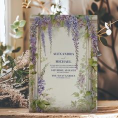 the wedding stationery is decorated with purple flowers and greenery for an elegant touch