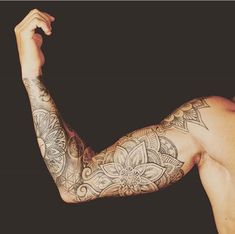 a shirtless man with tattoos on his arm