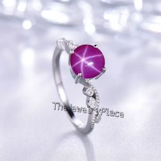 This Ring Features a 7X7 MM Round Cabochon Natural Lindy Star and Sterling Silver Finished with rhodium. Customization is available. It is made by hand, and it will take about 3 to 5 business days to finish the ring after your payment is completed. Product Details Main Stone: Natural Pink Lindy Star Metal Type: 92.5 Sterling Silver finished with rhodium Accent stone : Zircon How To take care of This Ring - Keep the jewelry away from direct heat, water, perfumes, deodorants, and other strong chem Silver Star-shaped Crystal Promise Ring, Silver Star-shaped Crystal Ring Gift, Silver Star-shaped Crystal Ring For Anniversary, Star Sapphire Ring, Ring Ruby, Star Sapphire, Star Ruby, Star Ring, Ring Promise