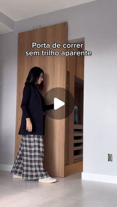 a woman standing in front of a wooden door