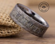 the wedding band is made out of wood and has an antler inlay on it