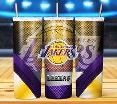 two tumblers with the los lakers logo on them, sitting on a basketball court