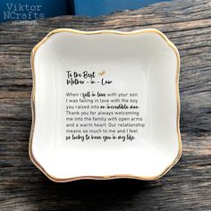 a white and gold plate with a poem on it