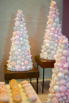 there are three small trees made out of cupcakes on the table next to each other