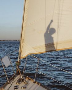 the shadow of a person on a sailboat