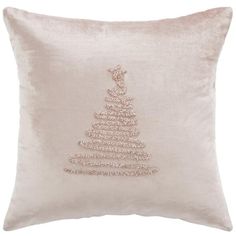 a white pillow with a christmas tree embroidered on the front and side, along with a light pink throw pillow