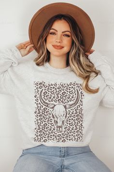 Longhorn Skull Shirt | Leopard Print Sweatshirt | Cowgirl Western Crewneck | Cheetah Print Hoodie :star: • I T E M • I N F O•✦ Gildan Unisex Sweatshirt✦ This is made from a cozy, thinner material- perfect year round! ✦ Printed using Direct To Garment style- Inks are printed directly into the fabric.✦ Different sizing may effect placement of final design.✦ Colors may differ slightly due to different user monitor and screen settings. Casual Cow Print Tops For Fall, Casual Long Sleeve Tops With Cow Print, Longhorn Sweatshirt, Casual Long Sleeve Cow Print Top, Graphic Print Crew Neck Shirt For Rodeo, Rodeo Crew Neck Top With Screen Print, Longhorn Skull Shirts, Western Graphic Sweatshirt, Austin Bachelorette