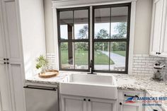 a kitchen with white cabinets and marble counter tops, an open window to the yard