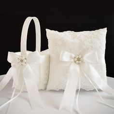 two white wedding pillows with bows on them