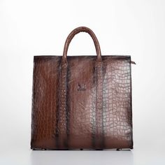 Elevate your professional ensemble with our Handmade Brown Leather Business XL Bag, a perfect blend of luxury and functionality for the modern man. Expertly crafted from premium genuine leather, this bag features an elegant embossed pattern that exudes sophistication. The interior is lined with durable gabardine fabric, while sleek black nickel metallic elements add a contemporary touch. Designed with practicality in mind, this spacious bag includes an internal zippered pocket, a dedicated laptop compartment, and a leather mobile phone holder, ensuring all your essentials are organized and secure. The long, adjustable strap with broad padding offers comfort, making it ideal for daily business use or travel. Key Features: Sophisticated Design: Crafted from high-quality genuine leather with High-end Business Shoulder Bag Briefcase, High-end Business Briefcase Shoulder Bag, Luxury Briefcase With Top Carry Handle, Designer Square Satchel For Business, Designer Business Satchel With Large Capacity, Designer Business Shoulder Bag With Large Capacity, Designer Square Shoulder Bag For Business, High-end Business Bags, Designer Brown Bags For Business Trips