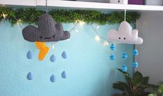 two crocheted clouds hanging from the ceiling