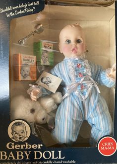 a baby doll in a box with other items