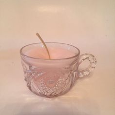 a glass cup with a candle in it