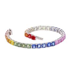 Handcrafted 15.81cts Rainbow Sapphire Tennis Bracelet in 18K White Gold - Unique Jewelry Gift STONE DETAILS : ❋ Stone : Rainbow Sapphire  ❋ Stone Size : 4 MM Approx. ❋ Stone Weight : 15.81 Cts. Approx. ❋ Stone Shape : Hexagon Cut ❋ Stone Color : As Shown In Picture ❋ Stone Type : Natural METAL DETAILS : ❋ Metal Purity : Solid 18K Gold  ❋ Metal Color : White Gold ❋ Bracelet Length : 6.5 Inches Approx. ❋ Gross Weight : 11.840 Gms. Approx. ❋ Gold Net Weight : 8.678 Gms. Approx. ❋ Making : Handmade Elegant Multicolor Tennis Bracelet As A Gift, Luxury Multicolor Tennis Bracelet As Gift, Elegant Rainbow Diamond Jewelry, Luxury Rainbow Cubic Zirconia Jewelry, Elegant Rainbow Colored Bangle Jewelry, Elegant Rainbow Round Bracelets, Multi-stone Cubic Zirconia Tennis Bracelet As Gift, Multicolor Cubic Zirconia Tennis Bracelet For Formal Occasions, Formal Multicolor Cubic Zirconia Tennis Bracelet