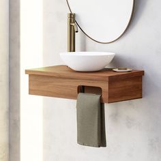 a bathroom sink sitting on top of a wooden counter next to a mirror and towel rack