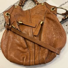 Authentic Oryany Leather Hobo Tote/Shoulder Bag With Gold Hardware. Very Gently Used And Loved! Lots Of Compliments. This Bag Is Practical, Spacious And Super Classy That Will Never Go Out Of Style. Condition Is Beautiful! Lots Of Zippers And Pockets, All Sturdy And Strong, Leather Is Very Luxurious And Healthy. For All My Listings, Reasonable Offers Are Welcome, Scamming Is Not! Every Item Sold Is Video Recorded And Packaging Documented Designer Shoulder Bag With Metal Hardware For Daily Use, Designer Shoulder Bag For Daily Use With Metal Hardware, Designer Crossbody Shoulder Bag With Leather Handles, Designer Shoulder Bag With Handle Drop, Designer Hobo Bag With Gold-tone Hardware, Designer Hobo Shoulder Bag With Leather Handles, Designer Hobo Bag With Handle Drop, Designer Hobo Bag With Leather Handles, Designer Hobo Shoulder Bag With Adjustable Strap