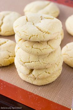 a stack of white cookies sitting on top of a cookie sheet next to other cookies