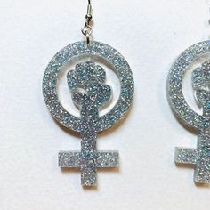 "Feminist power fist earrings cut from 3mm rainbow glitter acrylic. These earrings can be dressed up or dressed down and they make a great gift for a friend. The earrings measured 2\" tall and 1.2\" wide. Earrings will be placed in a gift box, carefully packed and shipped, perfect as a gift for yourself or a loved one. Any questions? Please feel free to contact me! Please note the colors may appear differently from device to device or from person to person. -------------------------------------- Feminine Symbols, Geometric Hoop Earrings, Glitter Acrylic, Pink Tassel, Glitter Earrings, Glitter Acrylics, Rainbow Glitter, White Doves, Under The Lights