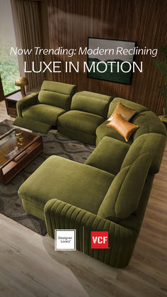 a large green couch sitting on top of a wooden floor next to a coffee table