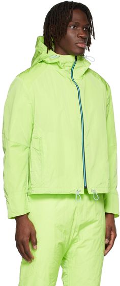 Long sleeve nylon taffeta jacket in green. · Zip closure with trim in blue · Bungee-style drawstring in blue at hood and hem · Concealed zip pockets at waist · Inset elasticized cuffs · Storm flap and patch pocket at back Avaible exclusively at SSENSE. Supplier color: Lime Green Track Jacket With Drawstring Hood For Outdoor, Green Long Sleeve Outerwear With Drawstring, Green Long-sleeve Outerwear With Drawstring, Green Sporty Outerwear With Drawstring, Sporty Green Outerwear With Drawstring, Spring Green Nylon Outerwear, Green Track Jacket With Drawstring Hood, Green Long Sleeve Track Jacket With Drawstring Hood, Green Hooded Functional Track Jacket