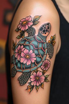 a woman with a tattoo on her arm has a turtle and flowers on it's shoulder