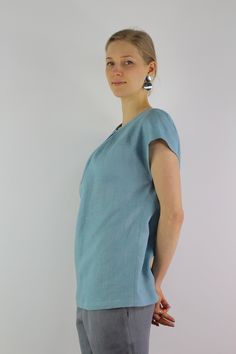 "Handmade turquoise linen blouse with short sleeves, perfect for casual wear and suitable for any occasion in any season Details: - 100% natural linen produced in Europe ; - medium weight (180 gram per square meter); - color: turquoise, can be any from our colors catalog (color samples at the photo); Made to order, approximately a few days, If you have any questions please message me and I will be glad to answer. Size guide : Size XS Bust: fits bust around 33\"-34\"/ 84-88 cm Waist: fits waist a Blue Linen V-neck Blouse, Light Blue Linen Short Sleeve Top, Light Blue Linen Summer Blouse, Turquoise Short Sleeve Tops For Spring, Light Blue Relaxed Fit Linen Tops, Relaxed Fit Light Blue Linen Tops, Light Blue Short Sleeve Blouse For Beach, Turquoise Short Sleeve Top For Summer, Light Blue Short Sleeve Summer Blouse