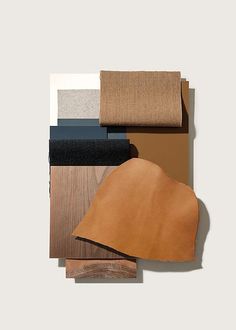 several different colors of wood are arranged on top of each other, including tan and black