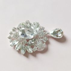 This listing you will receive 2 Flat back rhinestone drop. silver metal back. size in 56x35 mm If you want special order please contact me, Please take a look this link for my flowers. https://www.etsy.com/shop/Mydesign63 Thanks for looking Silver Jeweled Brooch For Wedding, Silver Jeweled Wedding Brooch, Silver Jeweled Wedding Brooches, Flower Button, Button Flowers, Pearl Drop, Clear Rhinestones, My Flower, Metallic Silver