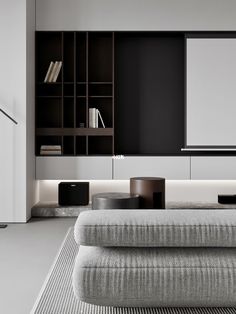 a modern living room with black and white furniture, bookshelves, and shelves