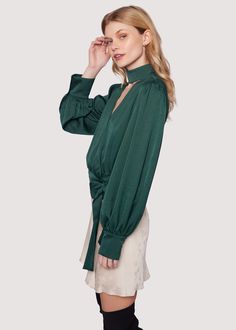 Elevate your style with the Calla Green Wrap Top! This chic piece that's perfect for fall combines a sophisticated mock neck with an open V-neck, elegantly wrapping around the waist and tying into a bow, while long loose sleeves add an extra touch of flair. WTWC02627-2 Imported Model is 5 ft 9 inches; Bust: 32", Waist: 23.5", Hips: 35" and wearing a size Small Runs true to size Hand wash or wash with gentle cycle with cold water with like colors, Air dry to avoid shrinkage. Green Wrap, Loose Sleeves, High Hips, Swim Accessories, Short Rompers, Wrap Top, Skirt Pants, Air Dry, Different Styles