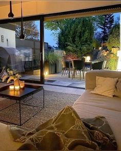 a living room filled with furniture next to a large sliding glass door that opens onto a patio