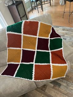 a crocheted blanket sitting on top of a couch