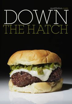 a hamburger with cheese and lettuce on it is shown in front of a black background