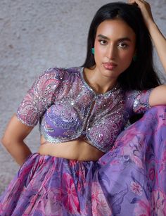 Stand out with the Lilac Printed Organza Lehenga Set, exuding unique charm and elegance. Made from organza fabric, this exquisite lilac lehenga flows gracefully, adorned with a mesmerizing floral print pattern in vibrant hues of pink and purple. Teamed with an intricately embroidered blouse showcases delicate beadwork and sequin embellishments, adding a touch of elegance and sophistication. Completed the look with a beautifully embroidered sheer organza dupatta that drapes effortlessly, featuring matching embroidery for a perfect blend of tradition and contemporary style. Ideal for brides-to-be at Mehendi or Sangeet ceremonies, this outfit promises to make you shine with unparalleled grace. Composition : Lehenga - Organza, Dupatta - Organza, Blouse - Organza Care: Dry Clean Only and Vacuum Lilac Lehenga, Mahima Mahajan, Printed Lehenga, Organza Lehenga, Embroidered Dupatta, Floral Prints Pattern, Organza Dupatta, Organza Fabric, Bride Bridal