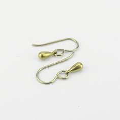 "Tiny gold color anodized titanium teardrop earrings are a pretty staple piece for your sensitive ears. They dangle from titanium French earwires hooks. The titanium is colored through anodizing, this makes the outer layer thicker with titanium and doesn't add other metals, so it is still pure titanium, but colored a beautiful yellow gold. These earrings are completely made out of pure titanium findings and therefor safe for when you have severe nickel allergies. Simple jet feminine for everyday Gold Hypoallergenic Teardrop Earrings For Everyday, Gold Minimalist Teardrop Earrings With Lever Back, Adjustable Gold Teardrop Earrings With Ear Wire, Adjustable Gold Teardrop Earrings, Minimalist Hypoallergenic Metal Teardrop Earrings, Gold Hypoallergenic Pear-shaped Jewelry, Gold Hypoallergenic Brass Teardrop Earrings, Metal Teardrop Earrings With Lever Back, Brass Teardrop Drop Earrings For Pierced Ears