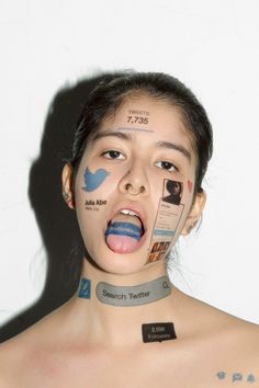 a woman with her face covered in stickers on her chest and the words twitter painted all over her body