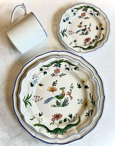 two plates with flowers and birds painted on them