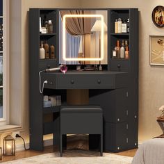 a black vanity with lighted mirror and stool