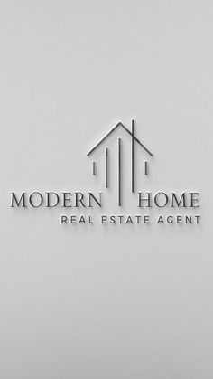 the modern home real estate agent logo is displayed on a white wall in front of a window