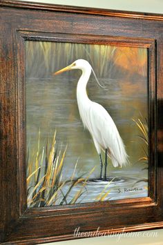 a painting of a white bird standing in the water