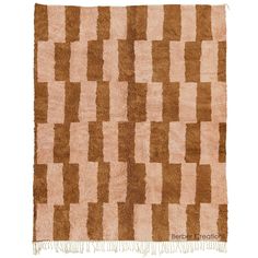 a brown and white rug with squares on it