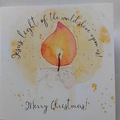 a christmas card with a lit candle on it