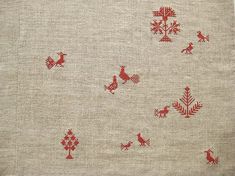 an old red and white cloth with small birds on the side, in various patterns