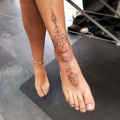 a close up of a person's foot with flowers on it and a band around the ankle