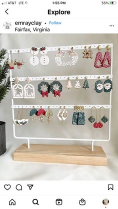 a white display rack with earrings on it